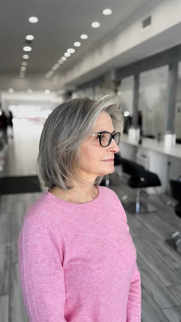 A soft, feathered silver-grey lob, swept back off the face.